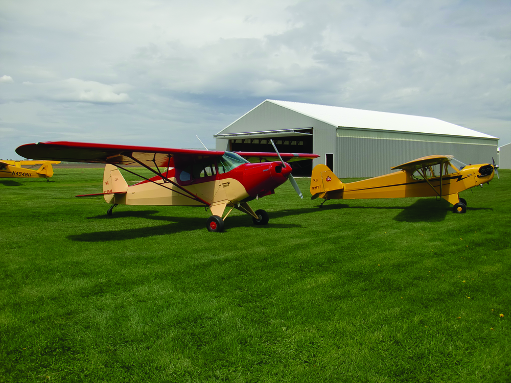 Newly restored PA-12 and J-3 at home at Stanton Airfield.