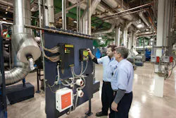 Operators reviewing refrigerant monitors. Operators reviewing refrigerant monitors.