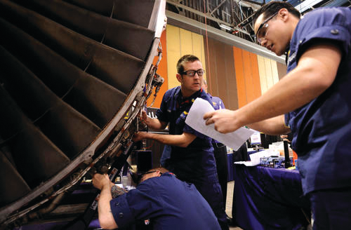 Petty Officer 2nd Class Josh Barrio (right) gives maintenance instructions to Petty Officer 1st Class Jacob Linder (top left) and Petty Officer 2nd Class Christopher Novak (bottom left) while the took part in an event during the AMT Society&rsquo;s Maintenance Skills Competition. U.S. Coast Guard photo by Petty Officer 3rd Class Seth Johnson.