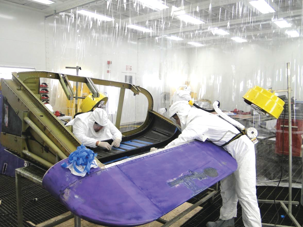 FedEx technicians in the new LAX composite shop repairing the carbon graphite inner skin stiffeners on a MD-11 tailcone.