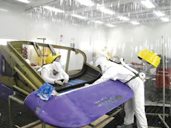 FedEx technicians in the new LAX composite shop repairing the carbon graphite inner skin stiffeners on a MD-11 tailcone. FedEx technicians in the new LAX composite shop repairing the carbon graphite inner skin stiffeners on a MD-11 tailcone.