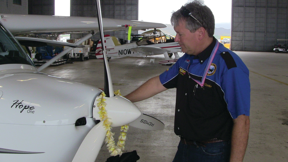Michael Combs shares an emotional moment with his REMOS aircraft named Hope One as he quietly reflects on the completion of his epic 40,000 mile, 50 state journey.