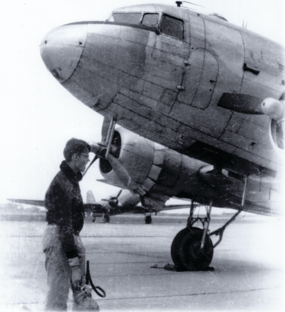 Tony Vasko, a CAP Cadet at age 15, holds a 10-pound CO2 extinguisher to be used, if needed, on the C-47 in the picture. 'If I look worried,' he says, 'I was.'