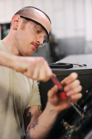 U.S. Air Force Senior Airman Robert Kitchens, 354th Maintenance Squadron aerospace ground equipment mechanic, installs a blower pressure gauge on a cabin leakage tester at Eielson Air Force Base, Alaska. The cabin leakage tester provides a means of pressurizing and automatically measuring the leakage rate of an aircraft cabin.