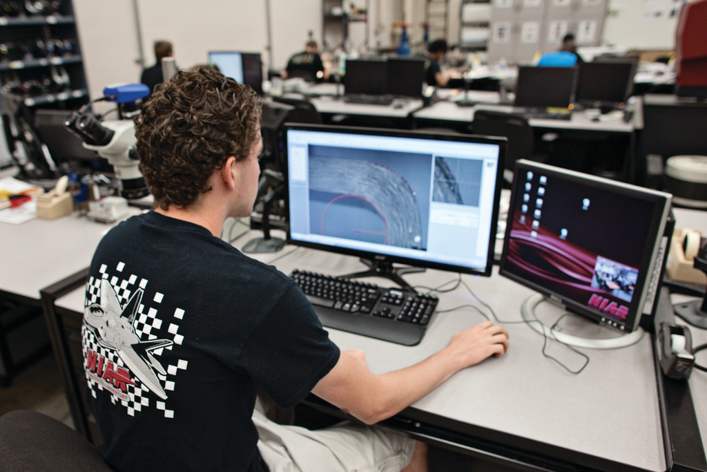 Student assistant Miguel Correa performs radius measurements on inter-laminate tension coupons in the Composites Laboratory at Wichita State University's National Institute for Aviation Research.