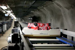 The replacement of multiple screening areas with a centralized area, fed by a high-speed tote transport system, offers a number of advantages, including a reduction in the number of screening machines that are required to provide the same capacity. The replacement of multiple screening areas with a centralized area, fed by a high-speed tote transport system, offers a number of advantages, including a reduction in the number of screening machines that are required to provide the same capacity.