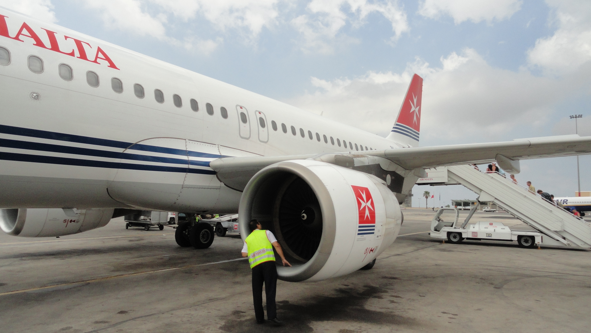 A crewman performs a pre-flight inspection on an Airbus A320.