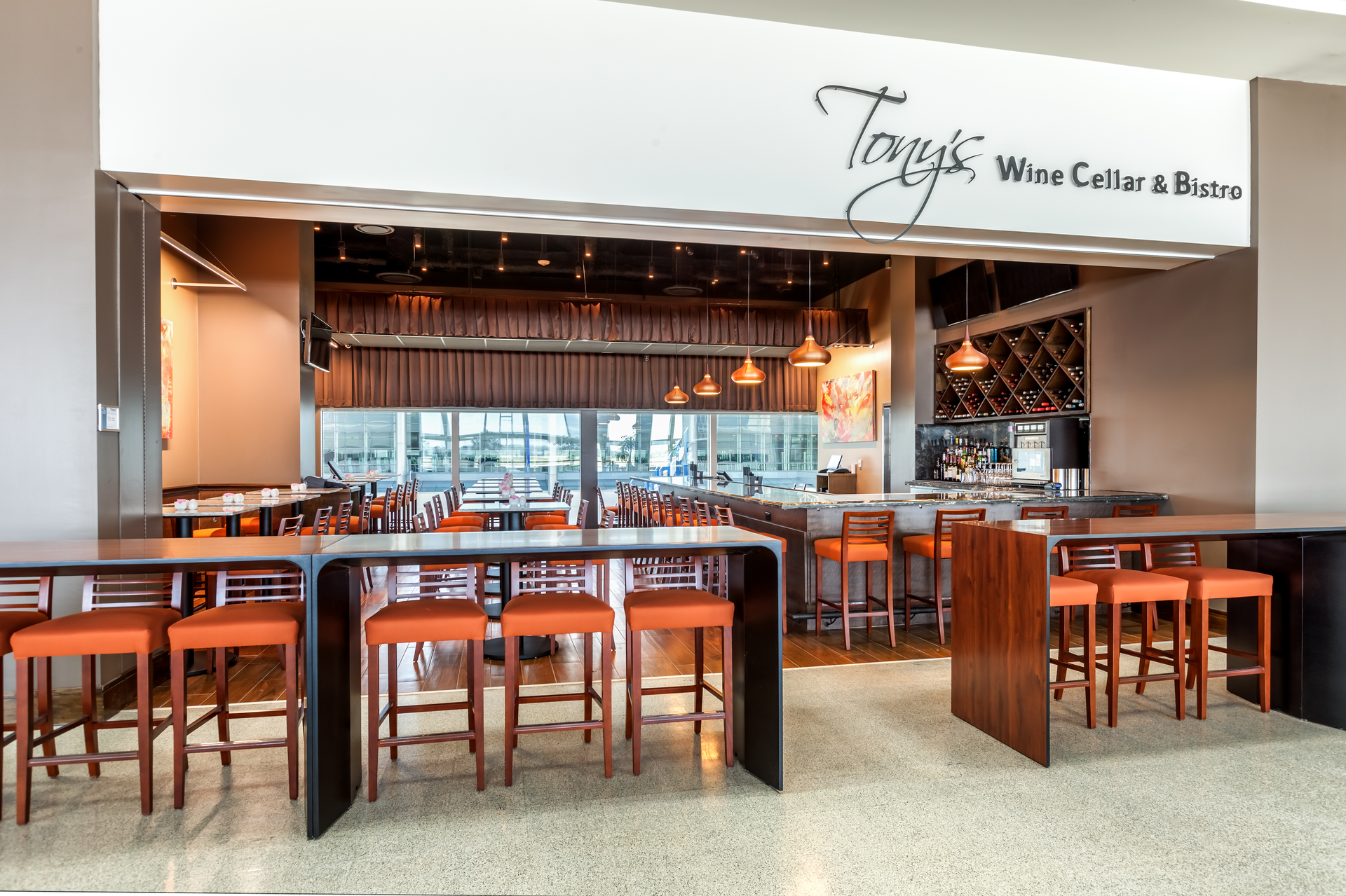 Tony&rsquo;s Wine Cellar & Bistro welcomes passengers from across the concourse with its impressive wine display and swank, focal point bar.