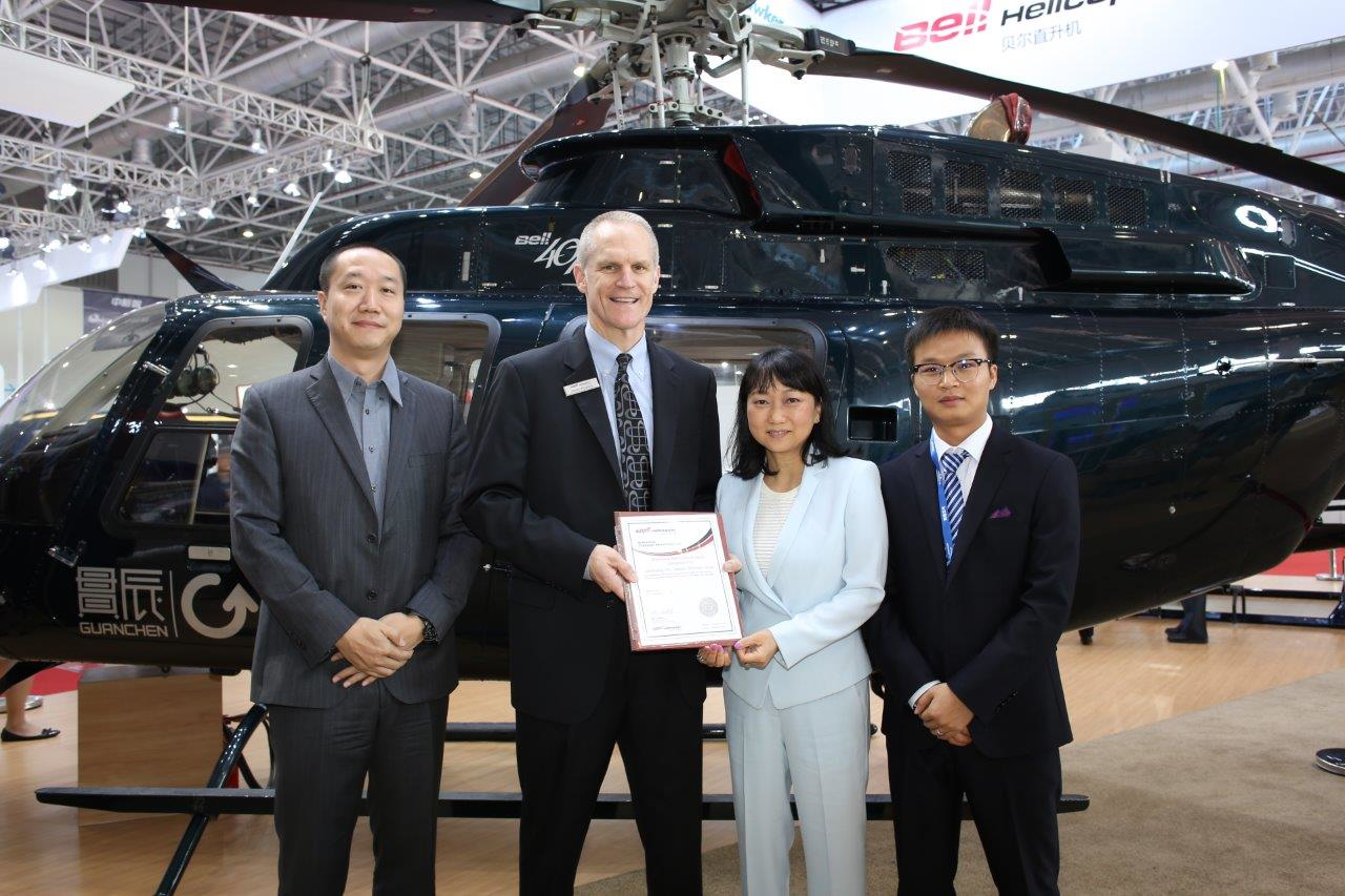 Diana Chou, chairwoman of Aerochine companies, receives the certificate of Authorized Customer Service Facility from Bell Helicopter.