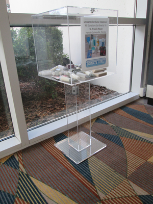 The airport helped get a secure box that would be appropriate for the waiting area near baggage claim. Passengers can drop items in the acrylic container on the way out the door.