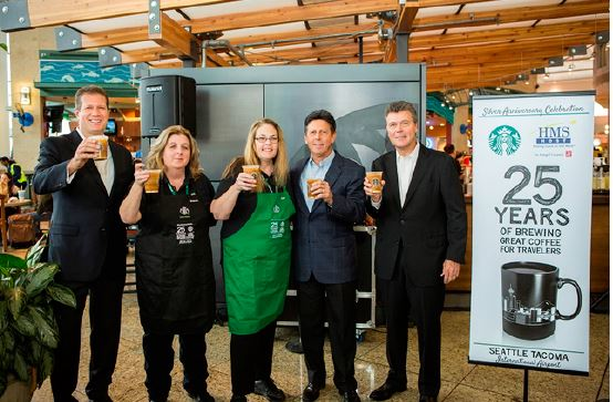 Toasting to 25 years of partnership, left to right, Steve Johnson, president and CEO, HMSHost; Brenda Canady-Valbush, Starbucks barista, HMSHost; Keri Krokenes-Williams, Starbucks barista, HMSHost; Jeff Yablun, EVP and chief operating officer, HMSHost; John Culver, president global retail, Starbucks.