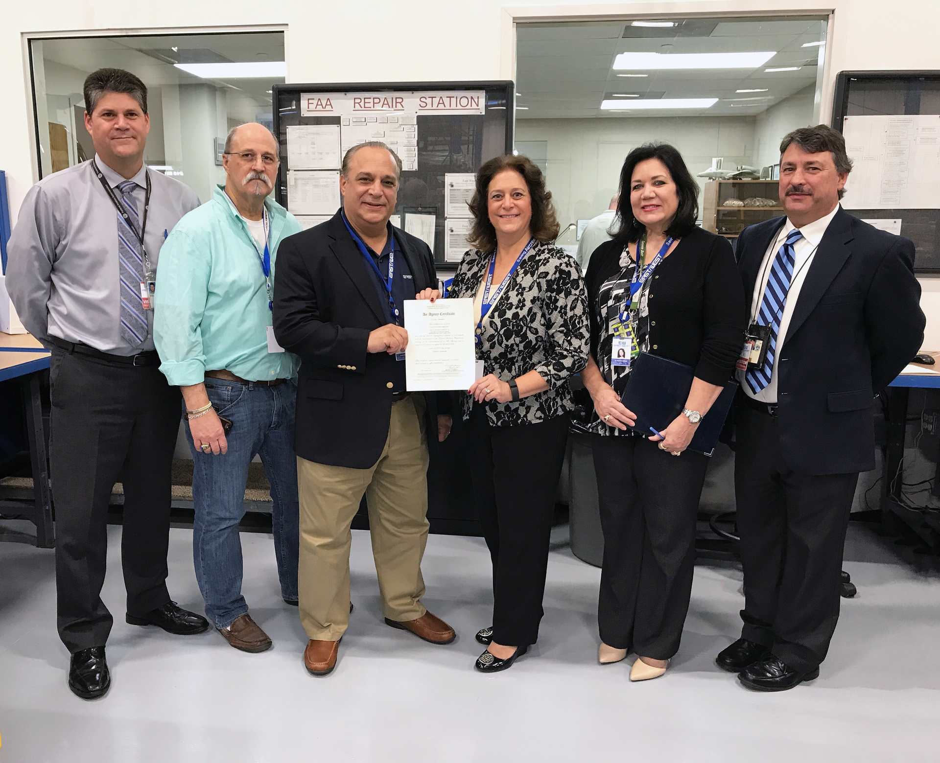 From left, Stanley Routh, FAA Aviation Safety Inspector - Airworthiness; Rob Miller, East/West Industries (EWI) Sr. Quality Engineer; Joseph Spinosa, EWI VP Business Development; Teresa Ferraro, EWI President; Liz Maida, EWI Process Improvements Manager; and Conrad J. DePinto, FAA ASI/PMI - Airworthiness.