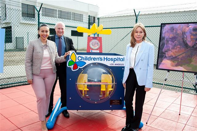 Councilwoman Nury Martinez (left), Board of Airport Commissioners member Jeffery Daar and Helinet Aviation Chief Executive Officer Kathryn Purwin stand with the newly dedicated play structure at the VNY observation area on Monday.