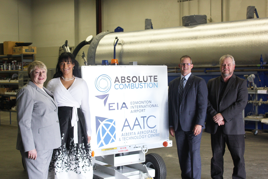From left to right: Laura Kilcrease, CEO of Alberta Innovates, Koleya Karringten, CEO of Absolute Combustion International, Steve Maybee, VP of Operations and Infrastructure, Edmonton International Airport and Rollie Dykstra, VP of Investments, Alberta Innovates, pose in front of the new Absolute Combustion International-SM1000 portable aircraft heater, tested and produced in Alberta.