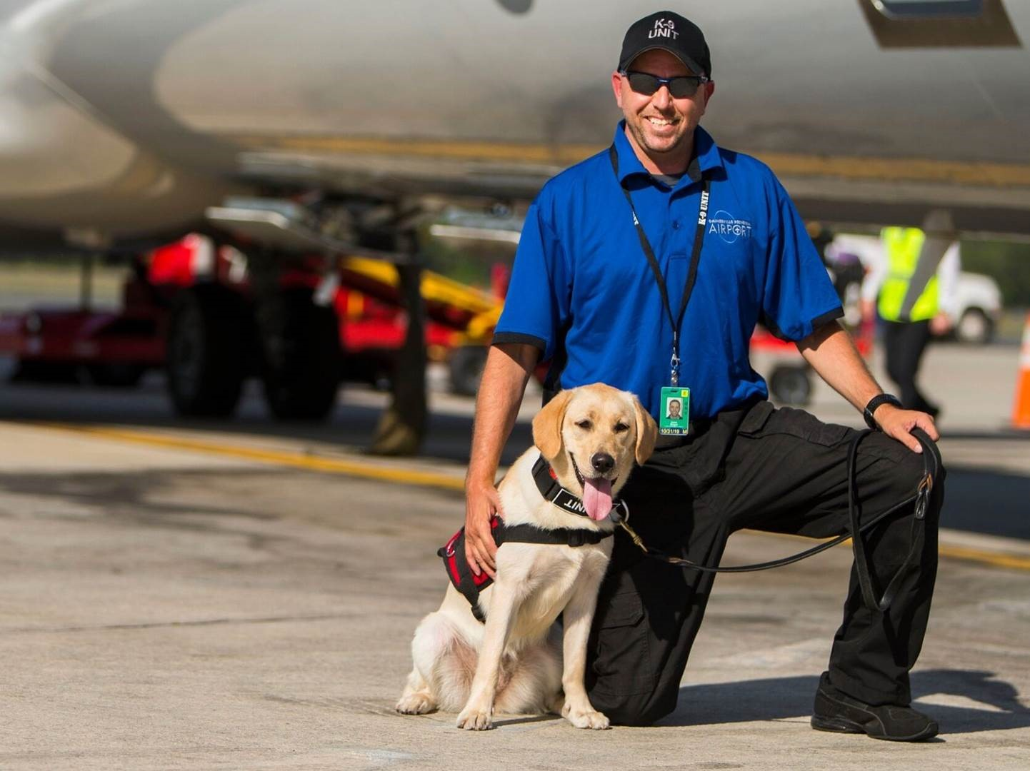 GNV K9 Beamer will receive a special protective vest from Vested Interest in K9s Inc, sponsored by Fairwood Pet Center in Renton, Wash. Left to Right: K9 Beamer and her handler, Jason Berger, GNV&rsquo;s K9 Handler (Explosives) and Airport Security Coordinator