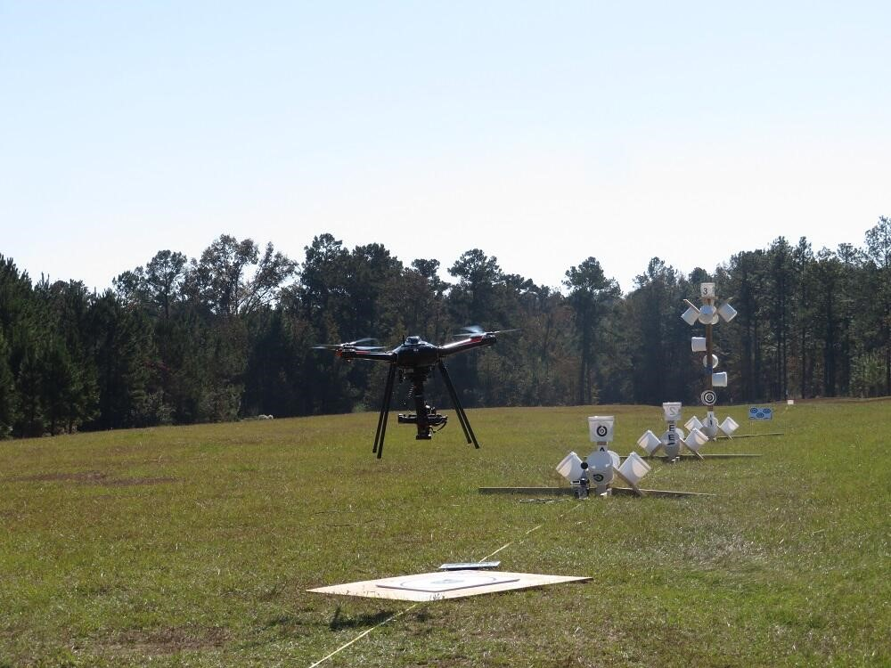 The eagle has landed! Eagle XF drone by SOLUTE, carrying a camera, lands after finishing the NIST test course (white buckets on stands) in Camp Shelby, Mississippi.
