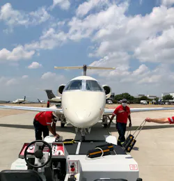 TAC Air-DAL workers securing the nose wheel for tow. TAC Air-DAL workers securing the nose wheel for tow.