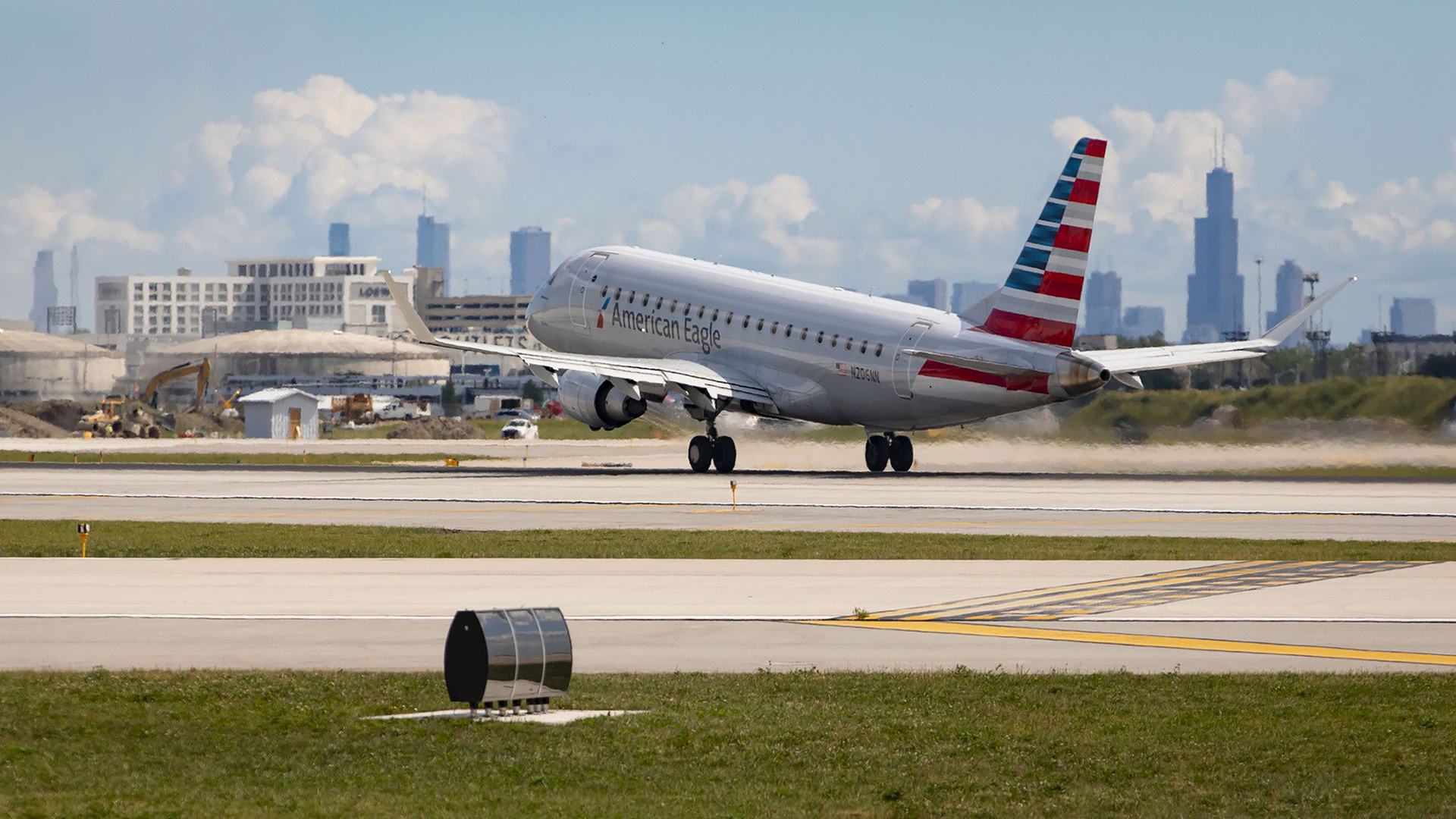 An American Eagle plane takes off in front of the Chicago skyline on Thursday, Sept. 9, 2021, at O'Hare International Airport.