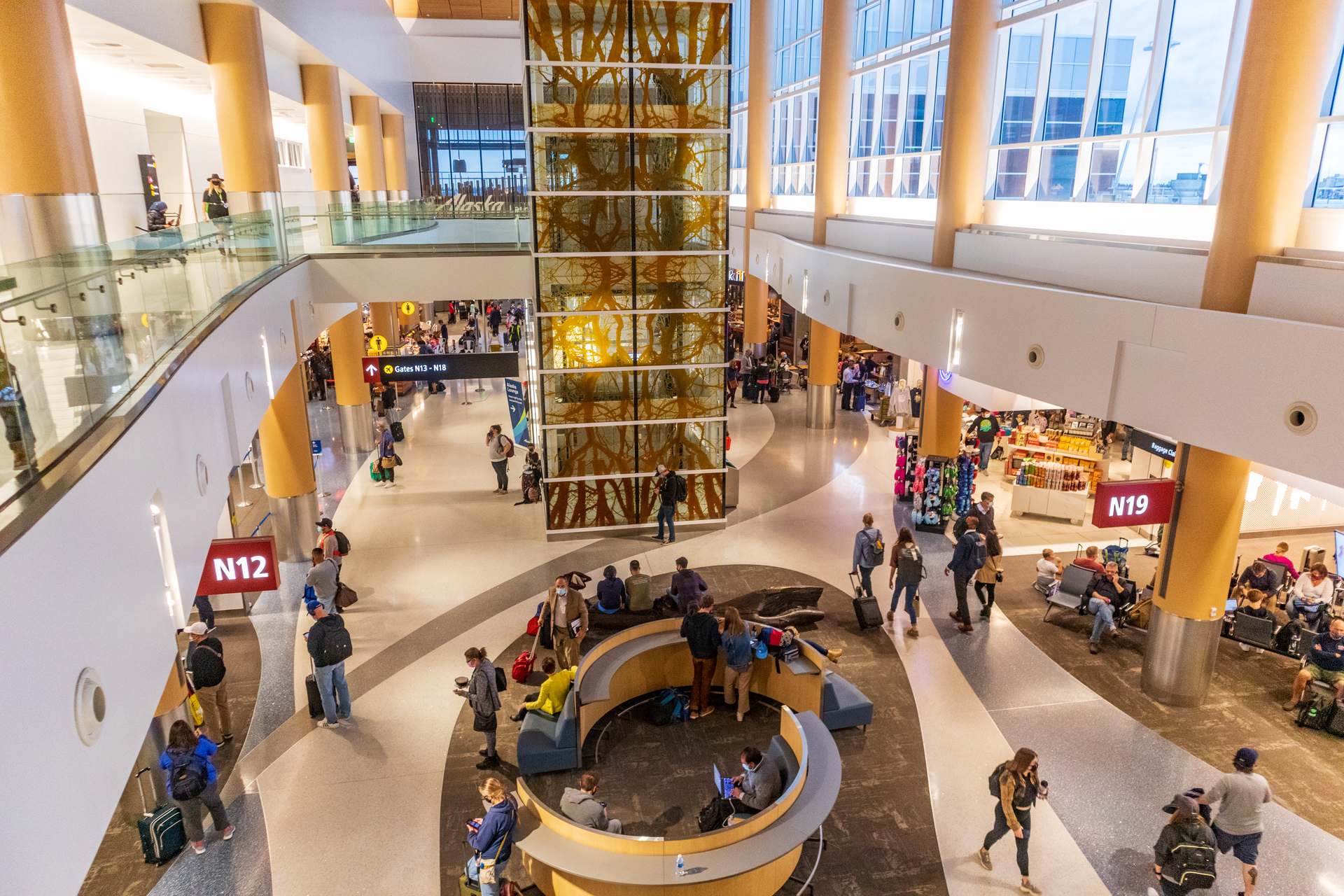 A permanent art installation in the SEA North Satellite consists of 20 custom glass panels and one large bronze tree log and was designed to re-contextualize the familiar.