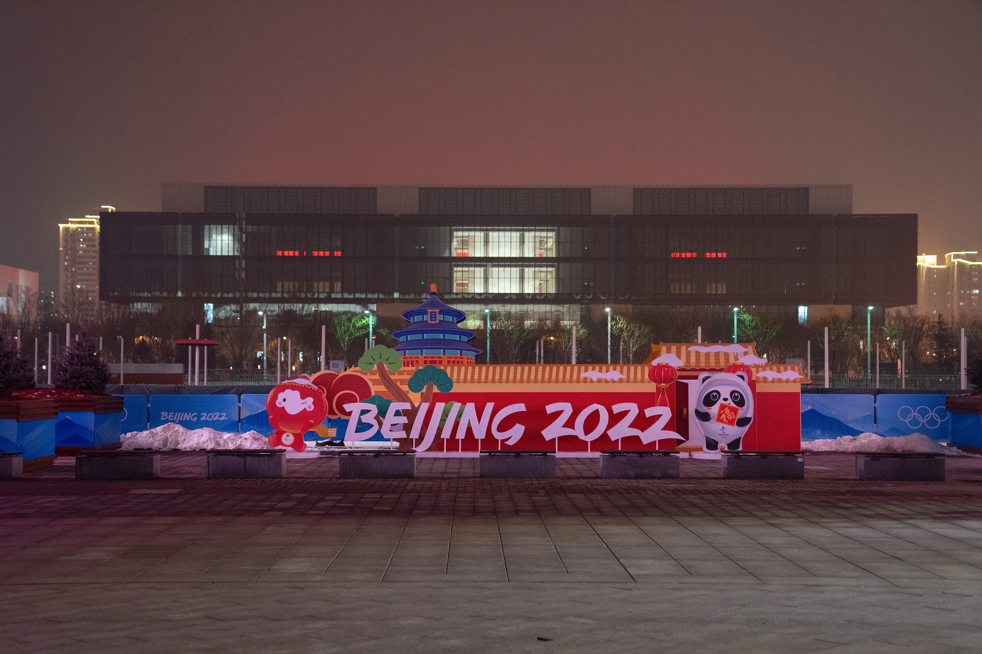 A Beijing 2022 Winter Olympics logo is displayed near the perimeter fence on the grounds of the main press center on January 24, 2022, in Beijing, China. With just over one week to go until the opening ceremony, final preparations are being made in Beijing ahead of the forthcoming 2022 Winter Olympics.