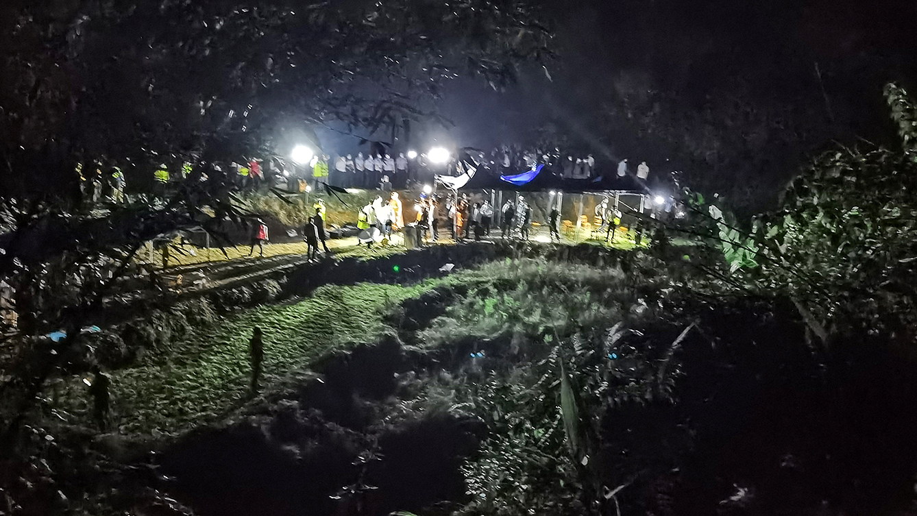 This photo taken on March 21, 2022, shows rescuers working at the site of a plane crash in Tengxian county, Wuzhou city, in China's southern Guangxi region. A China Eastern passenger jet carrying 132 people crashed onto a mountainside in southern China on March 21 causing a large fire, shortly after losing contact with air traffic control and dropping thousands of meters in just three minutes.