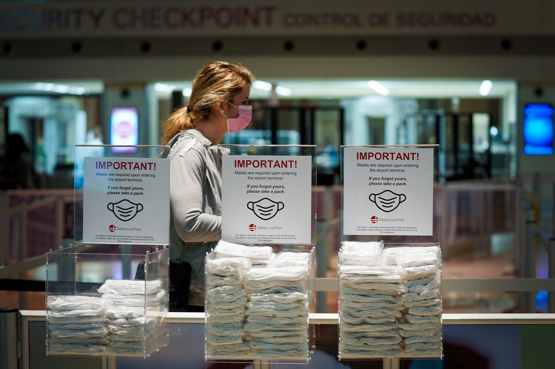 Bins of complimentary face masks are available to passengers passing through security screening at Dallas Love Field on Thursday, Jan. 7, 2021.