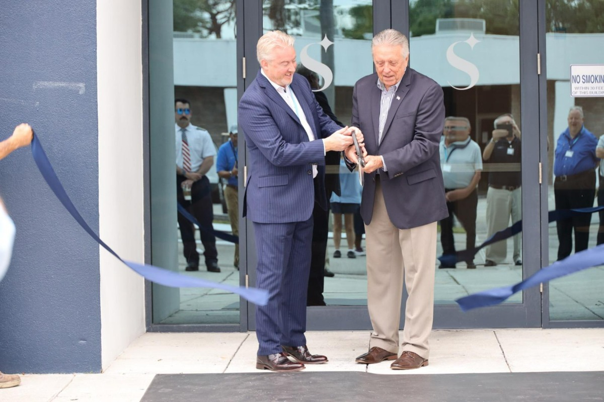 Lee Woodward, CEO, Skyborne (left), and Rick Monday, former Major League Baseball player and sports broadcaster (right), cutting the ribbon in front of the new training center.