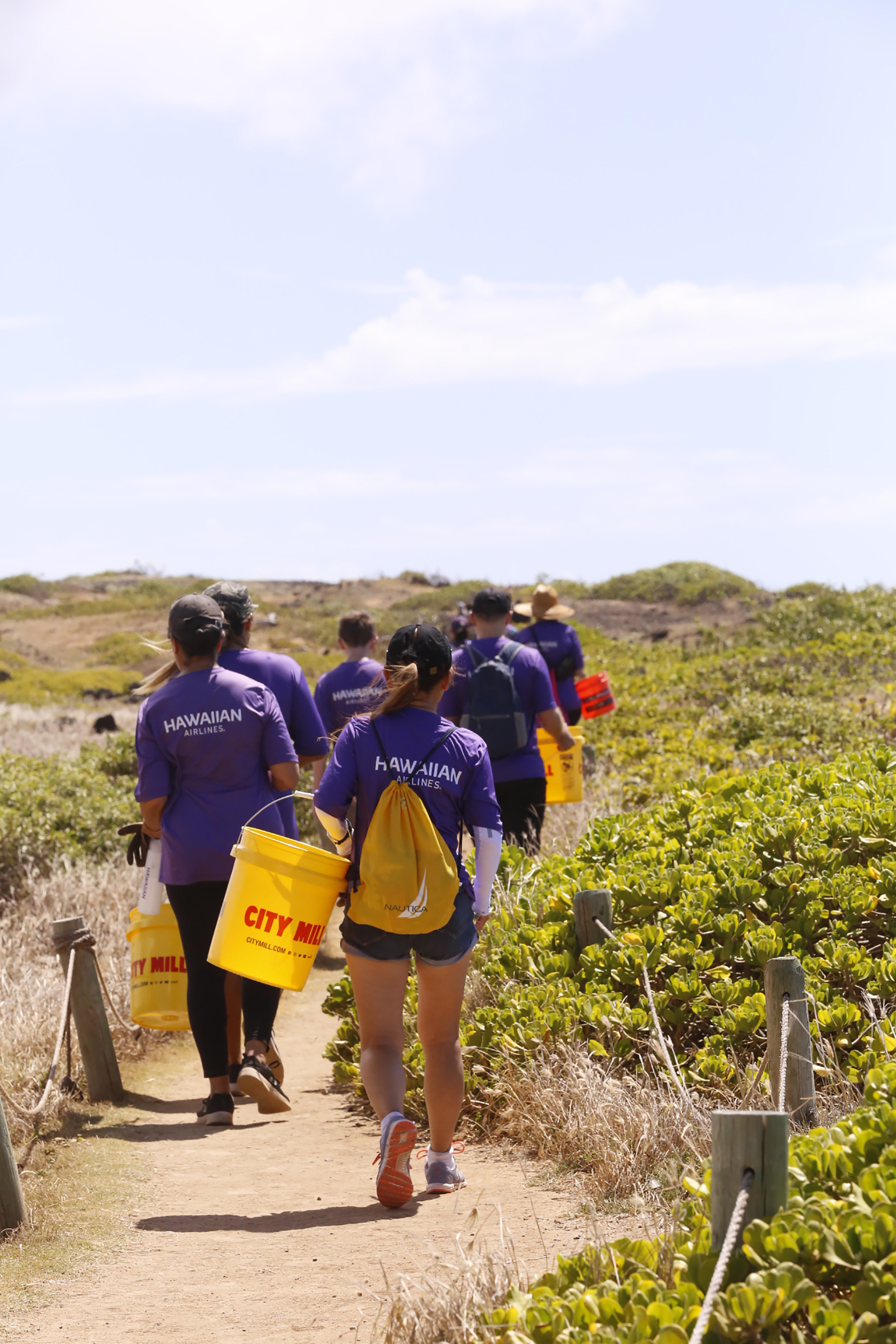 Team K&omacr;kua, Hawaiian Airlines' employee volunteer group, at a clean-up event at Oʻahu's Kaʻena Point State Park.