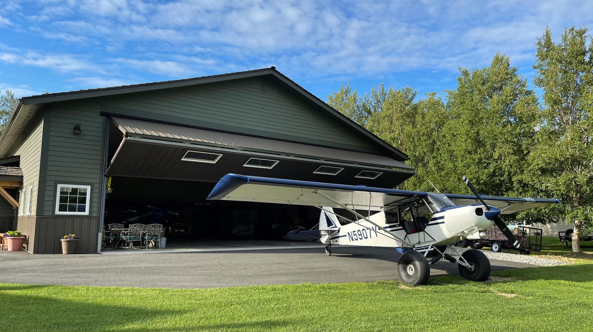 The 50-foot-by-50-foot hangar (shown here) is equipped with a Schweiss Doors bifold lift-strap door, complete with remote opener and automatic latching system.