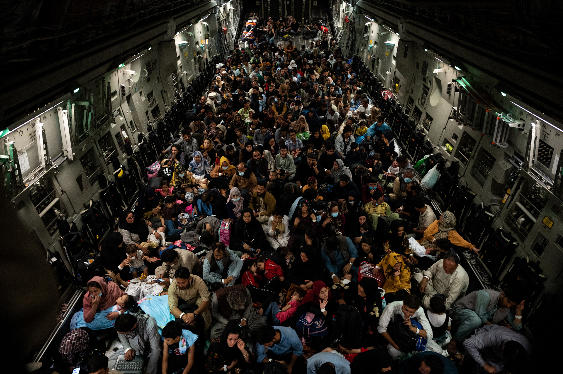 Afghan citizens rest in a U.S. Air Force C-17 Globemaster III after being evacuated from Hamid Karzai International Airport in Kabul, Afghanistan, Aug. 19, 2021. The U.S. Air Force conducted airlift operations to transport approximately 124,000 people from Kabul as part Operation Allies Refuge. The operation was one of the largest air evacuations of civilians in American history.