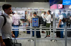 Departing passengers wait in line at a security checkpoint at Terminal C at DFW Airport on Oct. 22. Departing passengers wait in line at a security checkpoint at Terminal C at DFW Airport on Oct. 22.