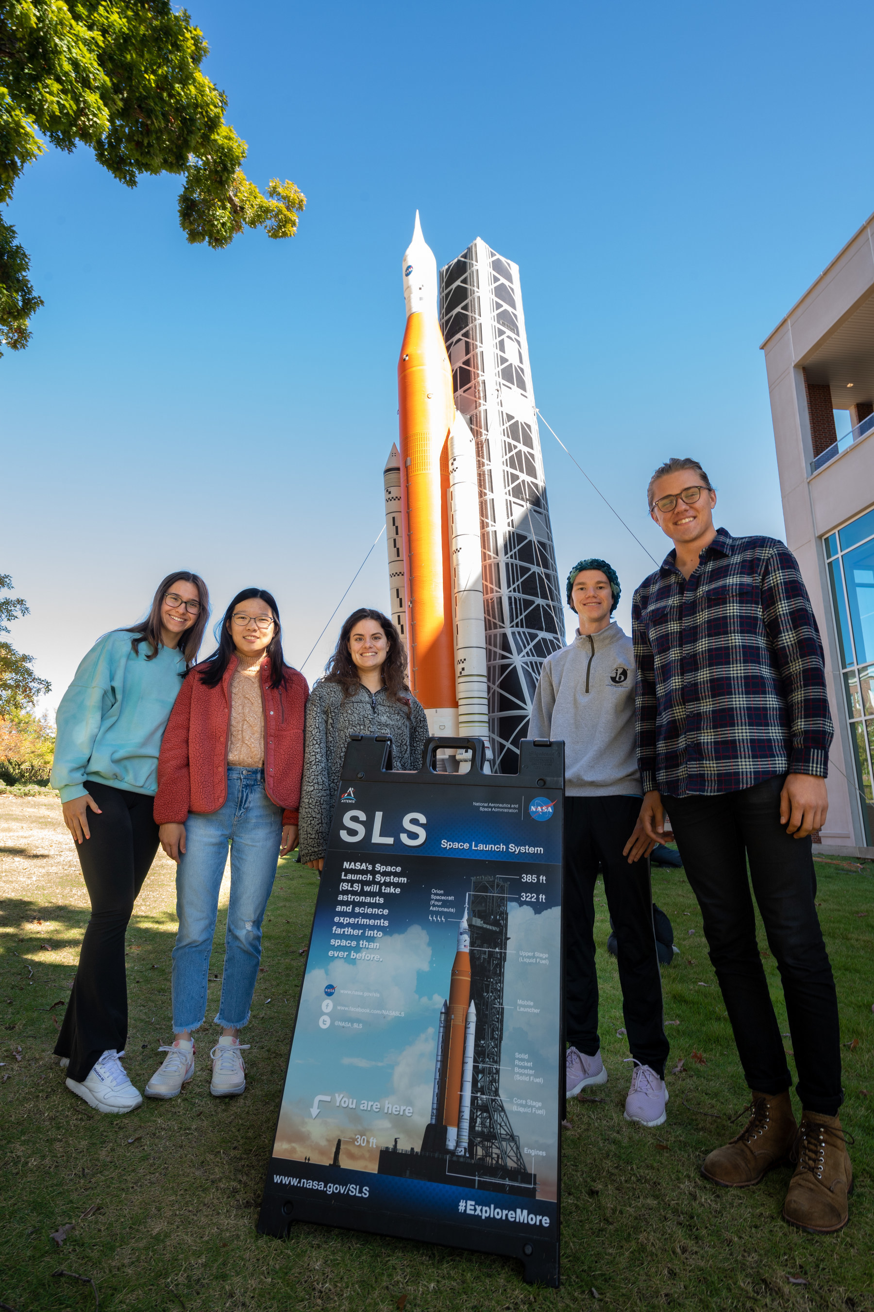 Student employees in the Industry Design Experience for Auburn Students, or IDEAS, program stand by a blow-up replica of the Space Launch System they are working on. Pictured are& Regan Clare, junior in mechanical engineering; Ashley Eng, junior in mechanical& engineering; Jessica Ruiz, junior in mechanical& engineering; Matthew Gillis, senior in mechanical& engineering& and applied mathematics; and Bradley Conrad, senior in mechanical engineering.