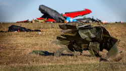 Debris lays across the open field at the Dallas Executive Airport on Nov. 13 after a Boeing B-17 Flying Fortress and a Bell P-63 Kingcobra collided in midair a day earlier. Debris lays across the open field at the Dallas Executive Airport on Nov. 13 after a Boeing B-17 Flying Fortress and a Bell P-63 Kingcobra collided in midair a day earlier.