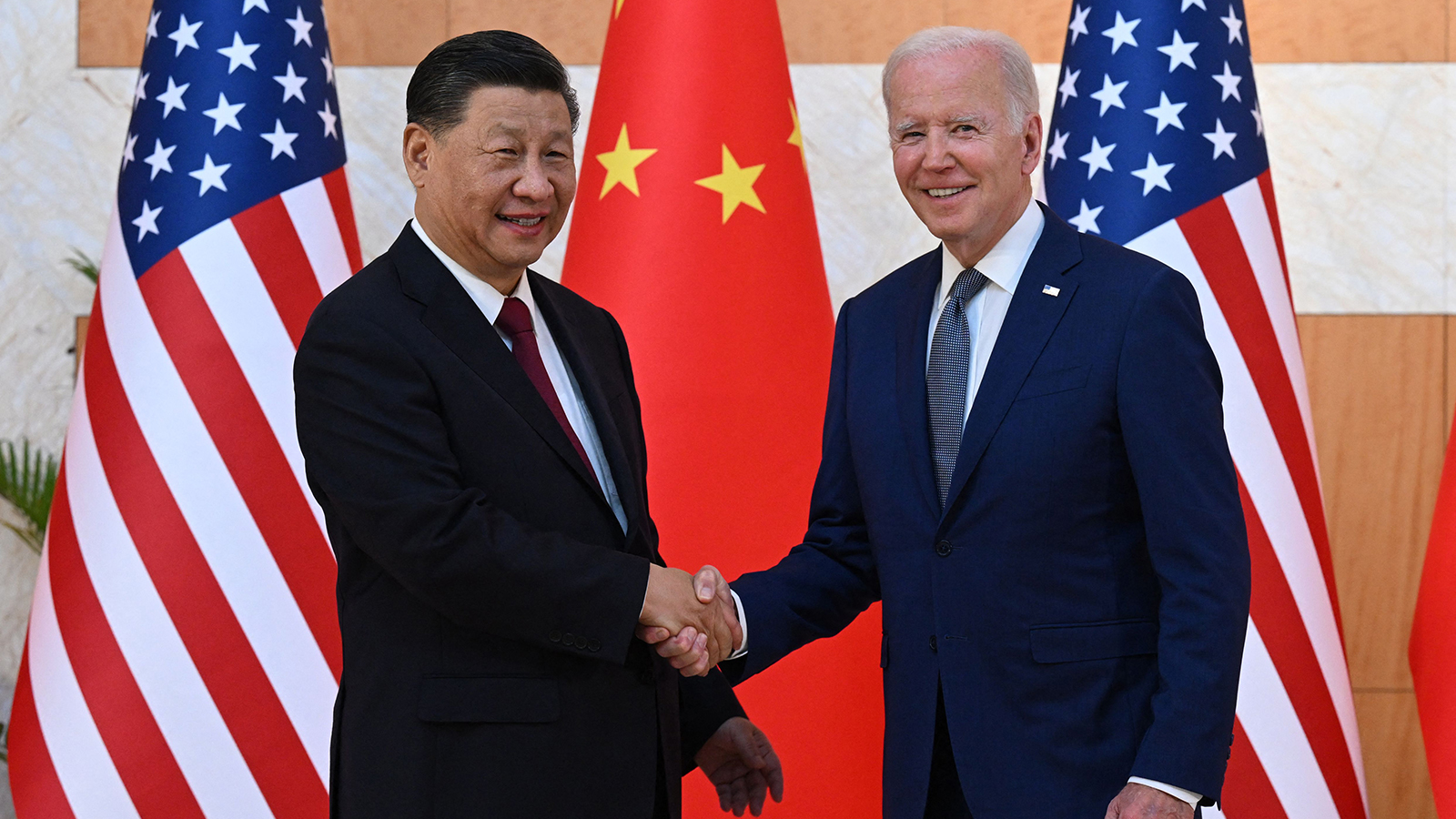 US President Joe Biden (right) and China's President Xi Jinping (left) shake hands as they meet on the sidelines of the G20 Summit in Nusa Dua on the Indonesian resort island of Bali on Nov. 14, 2022.