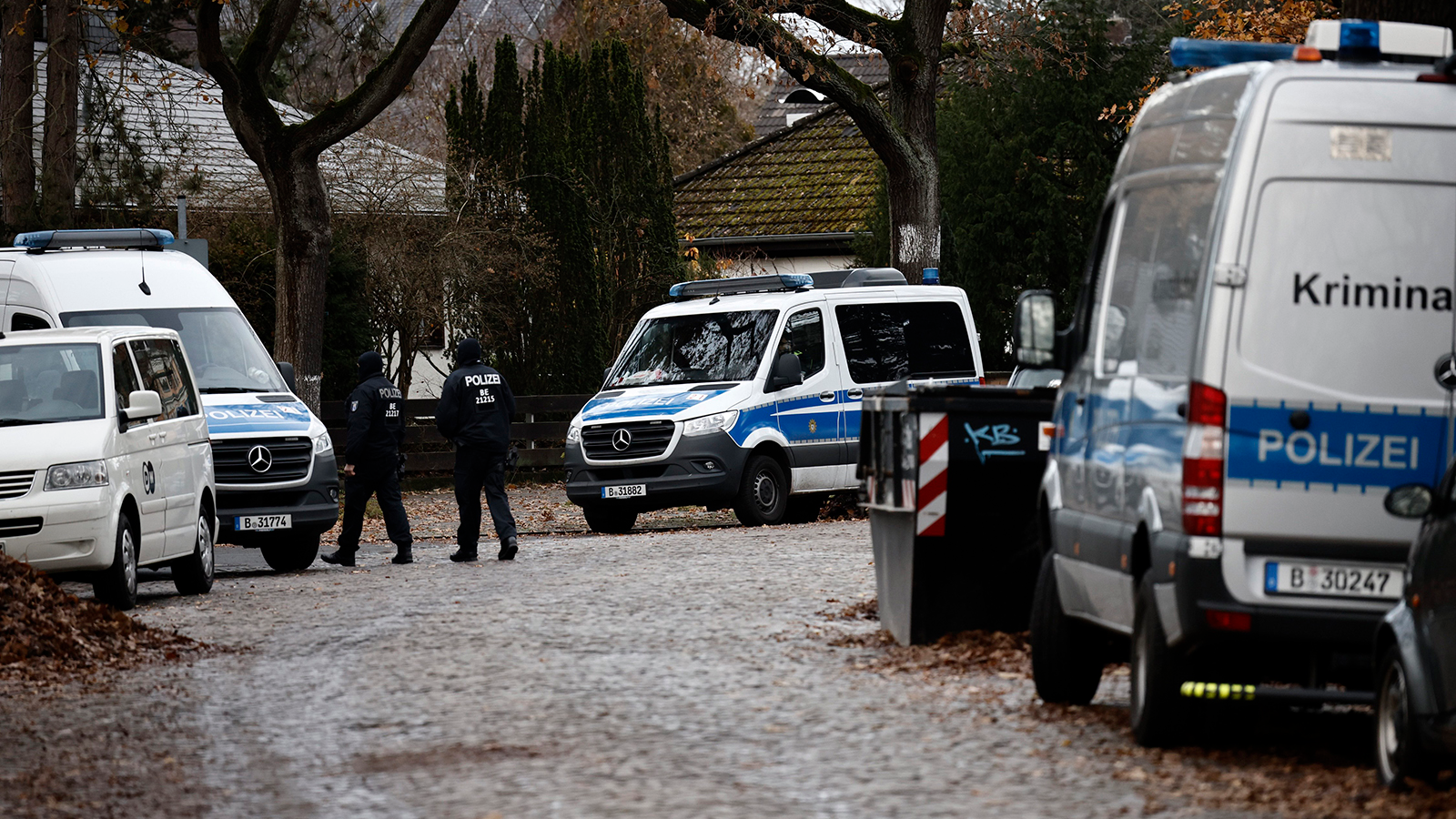 Police stand outside a residence that they raided earlier today on Dec. 7, 2022, in Berlin, Germany. Law enforcement agencies conducted raids nationwide today and arrested 25 people whom they claim are in an organization bent on violently overthrowing the German government.