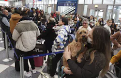 Emily Colfer and her dog, Archie, stand in the dog line in Terminal 1 at Chicago O Hare International Airport on Dec. 21, 2022. Colfer and her pup were on their way to Maine for the holiday season. Emily Colfer and her dog, Archie, stand in the dog line in Terminal 1 at Chicago O Hare International Airport on Dec. 21, 2022. Colfer and her pup were on their way to Maine for the holiday season.