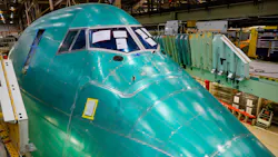 The giant nose section of the final 747 sticks up from beneath a deck before it is craned into position during the final body join. The giant nose section of the final 747 sticks up from beneath a deck before it is craned into position during the final body join.