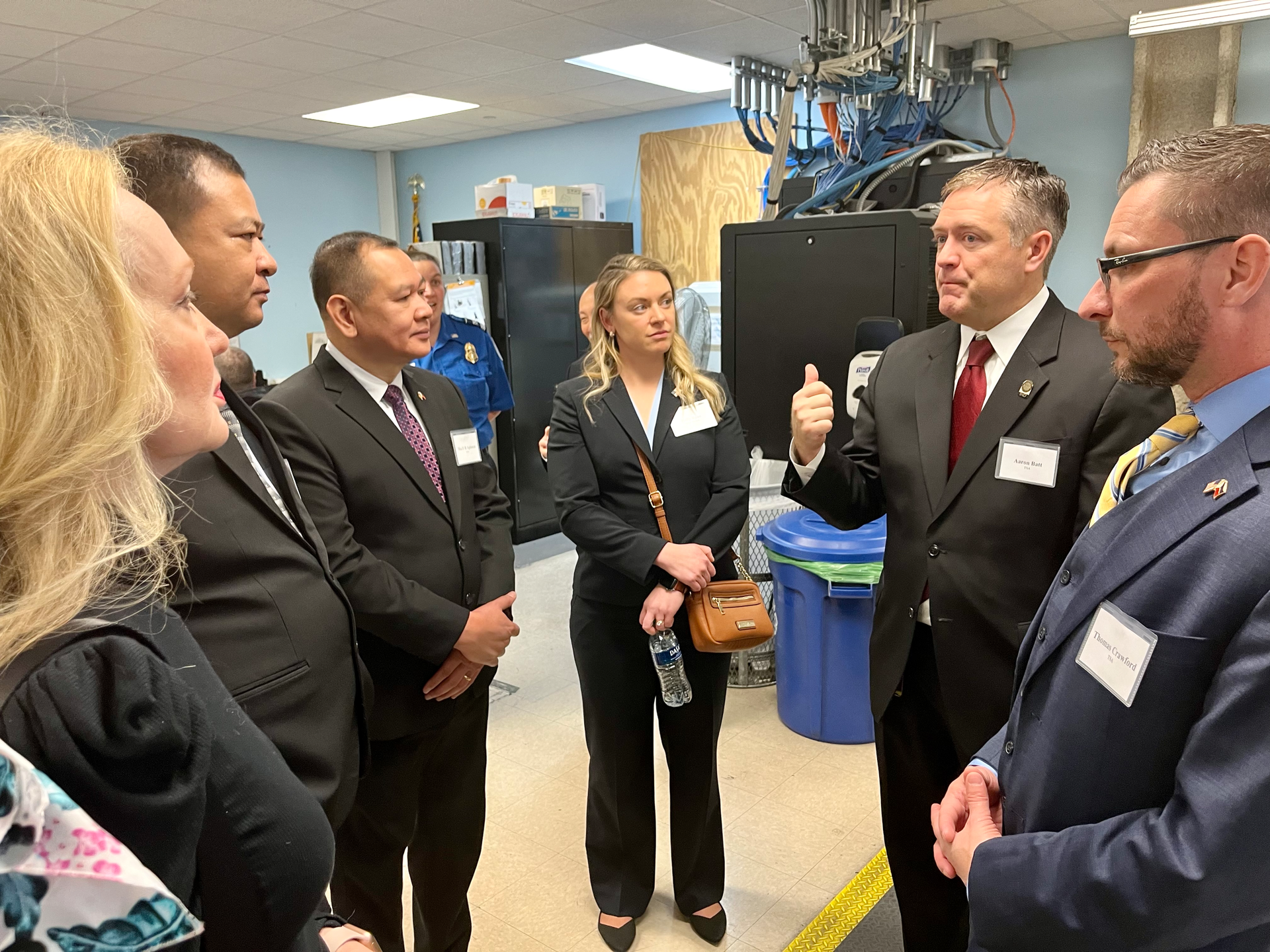 Indiana Federal Security Director Aaron Batt (second from right) explains security procedures to training participants and other guests at Indianapolis International Airport.