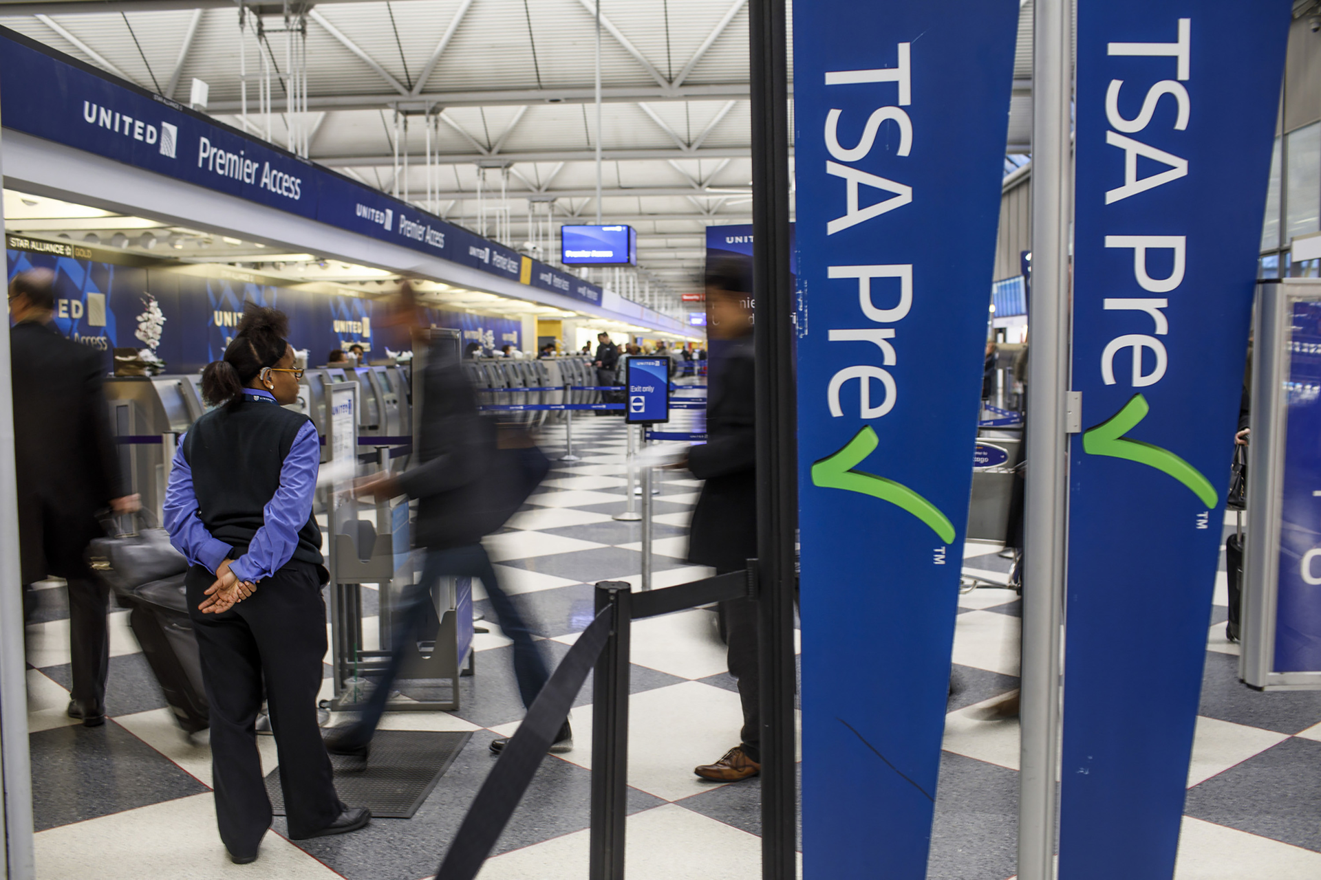 Passengers walk through the entrance of a TSA PreCheck in at O'Hare International Airport in 2017 in Chicago.
