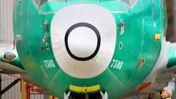 A Boeing employee looks up toward the sensor measuring the plane's angle of attack just below the cockpit of a 737 MAX 8 plane sitting outside the 737 factory in Renton, Washington on March 25, 2019. A Boeing employee looks up toward the sensor measuring the plane's angle of attack just below the cockpit of a 737 MAX 8 plane sitting outside the 737 factory in Renton, Washington on March 25, 2019.