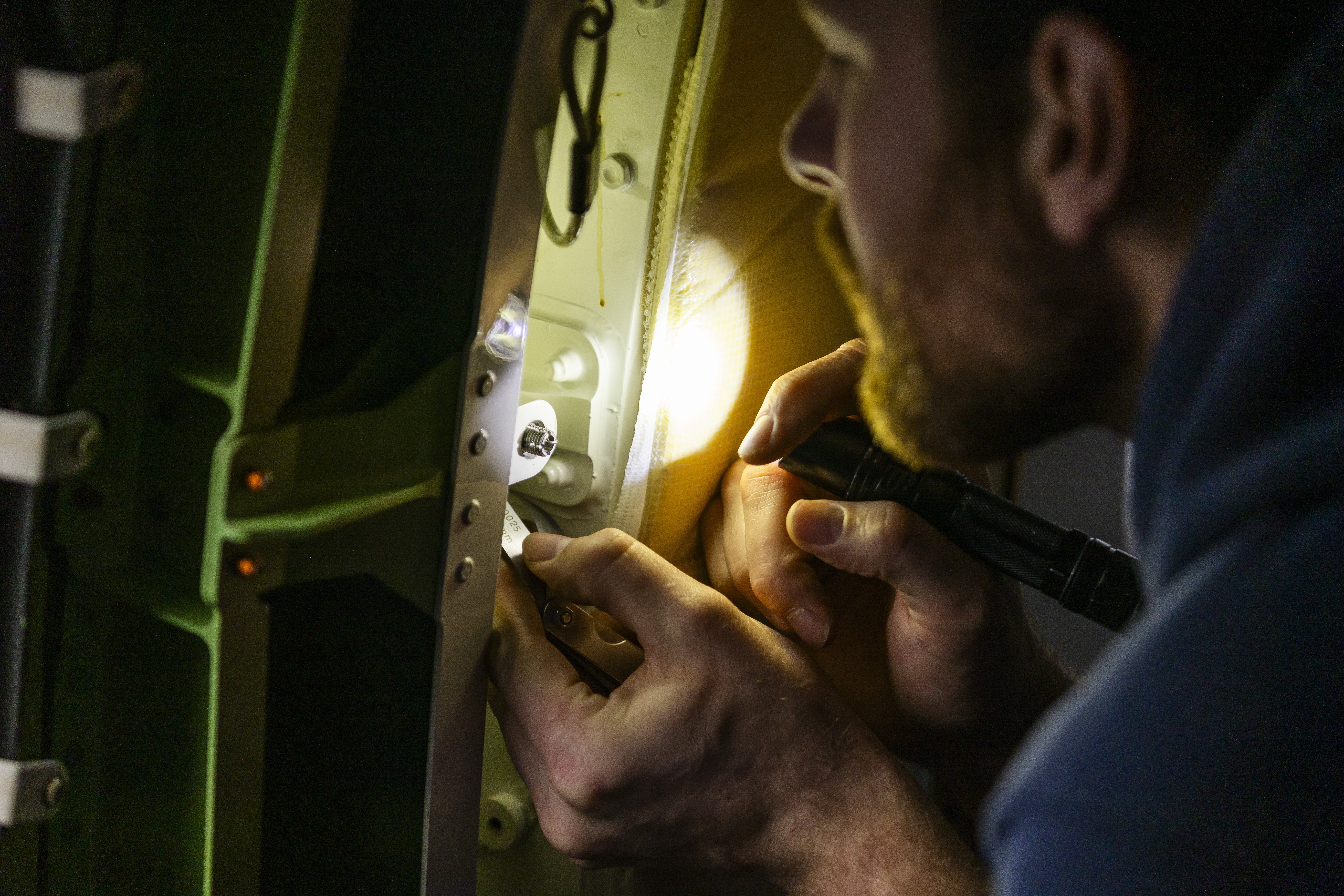 Alaska Airlines maintenance technicians inspect a Boeing 737-MAX 9 door plug prior to the aircraft returning to service. Photographed January 26, 2024 at Seattle-Tacoma International Airport (SEA) by Ingrid Barrentine / Alaska Airlines.