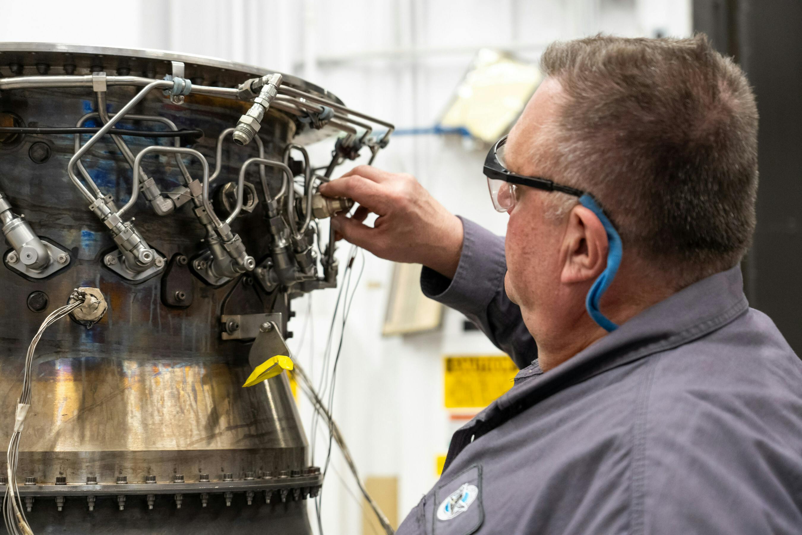 A Pratt & Whitney engineer inspects a full annular combustor rig at the company&rsquo;s test facility in Middletown, Connecticut.