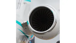 a close-up shot of an airplane engine attached to a white and light blue airplane a close-up shot of an airplane engine attached to a white and light blue airplane