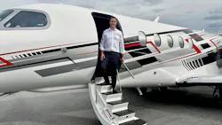 A man in business attire stepping out of a jet plane onto a staircase A man in business attire stepping out of a jet plane onto a staircase