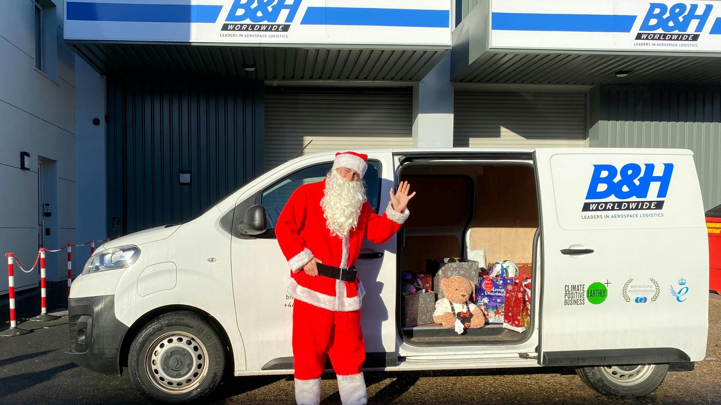 69441d78a8c741a521eb452d Bh Worldwide Ev Van Delivering Gifts