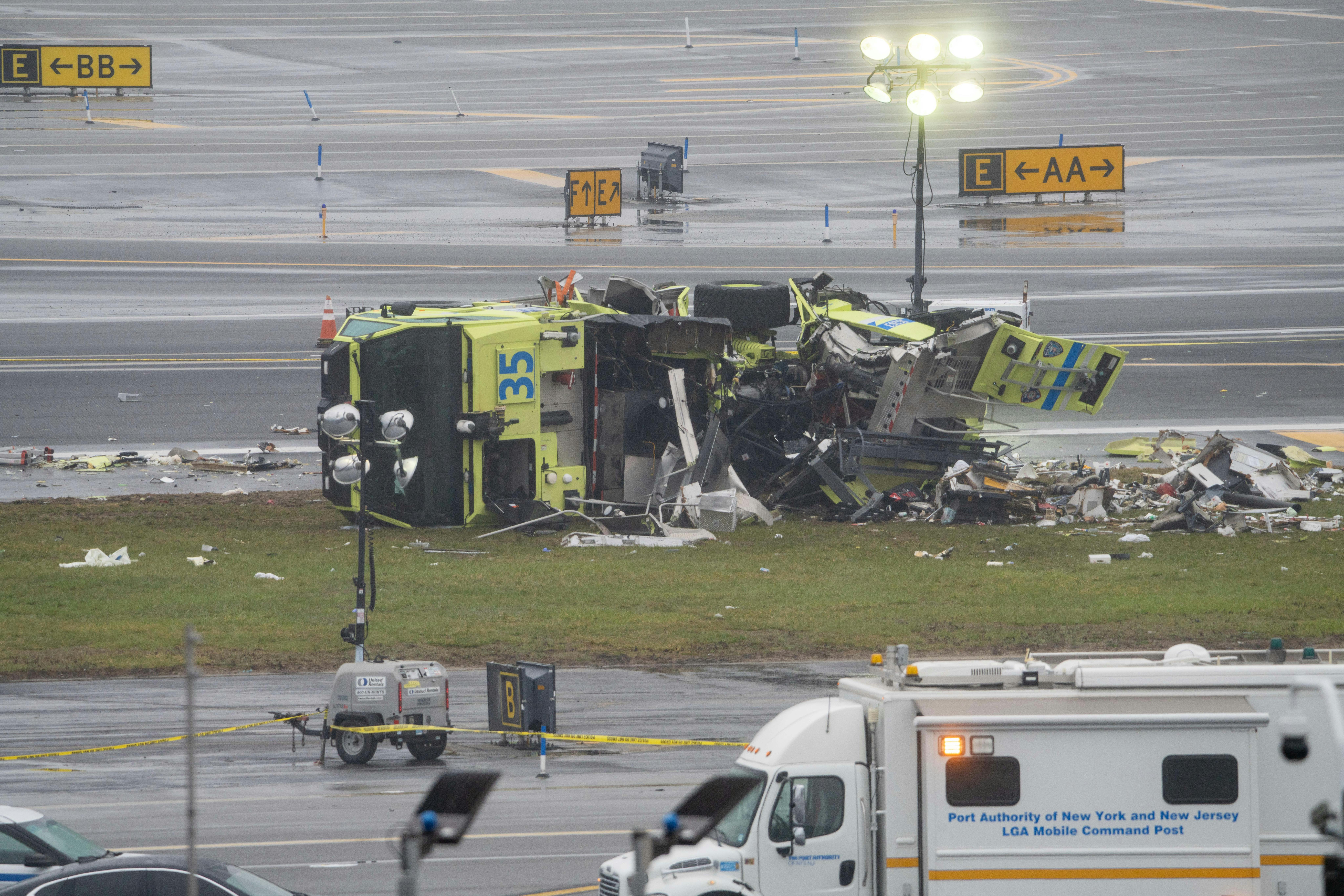 A destroyed Port Authority emergency vehicle is pictured after it collided with an Air Canada Express plane at LaGuardia Airport in Queens, New York, on Sunday, March 22, 2026.