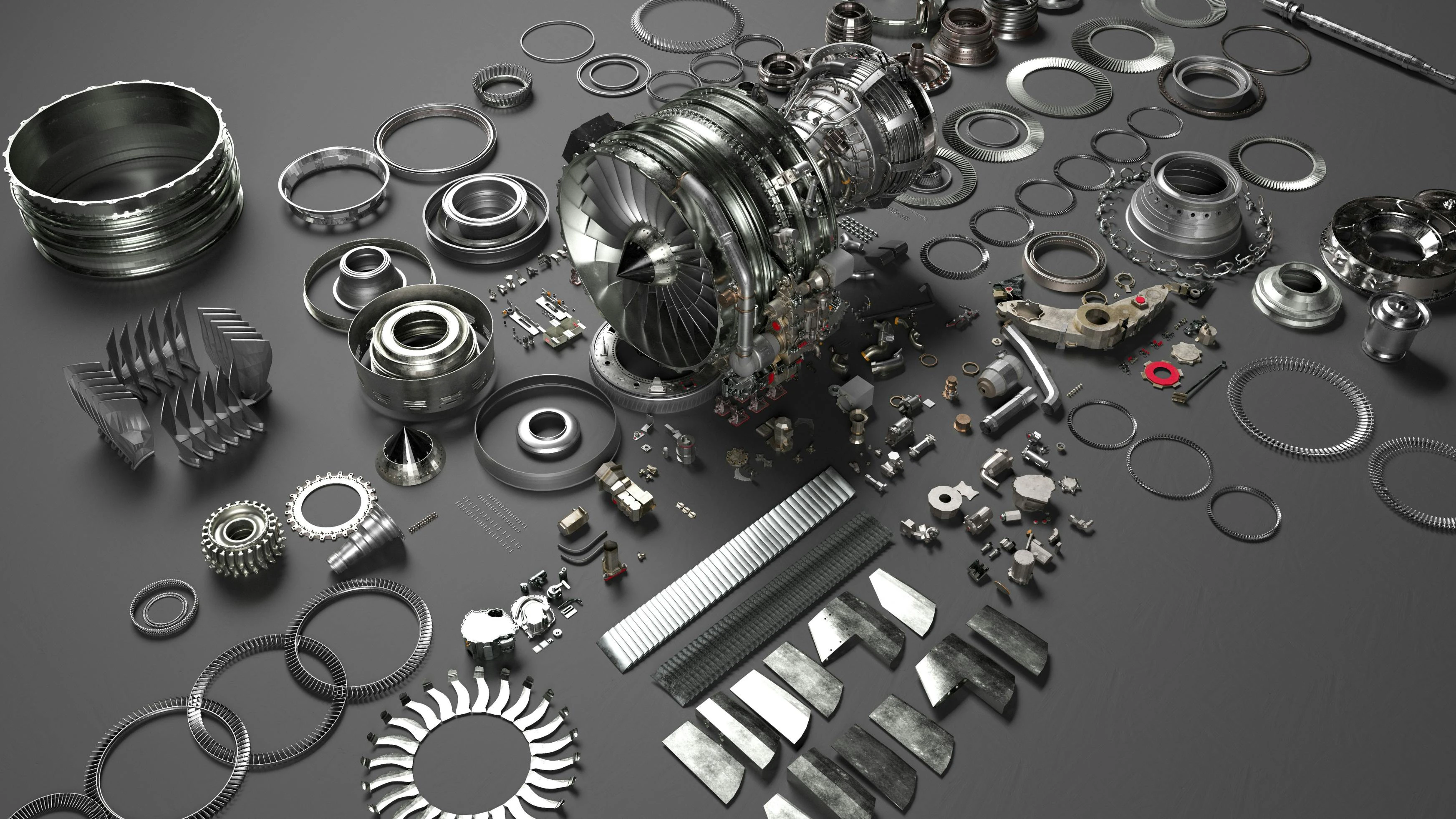 An array of metal airplane parts scattered on a gray surface