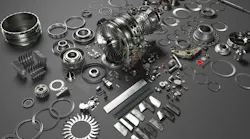 An array of metal airplane parts scattered on a gray surface An array of metal airplane parts scattered on a gray surface