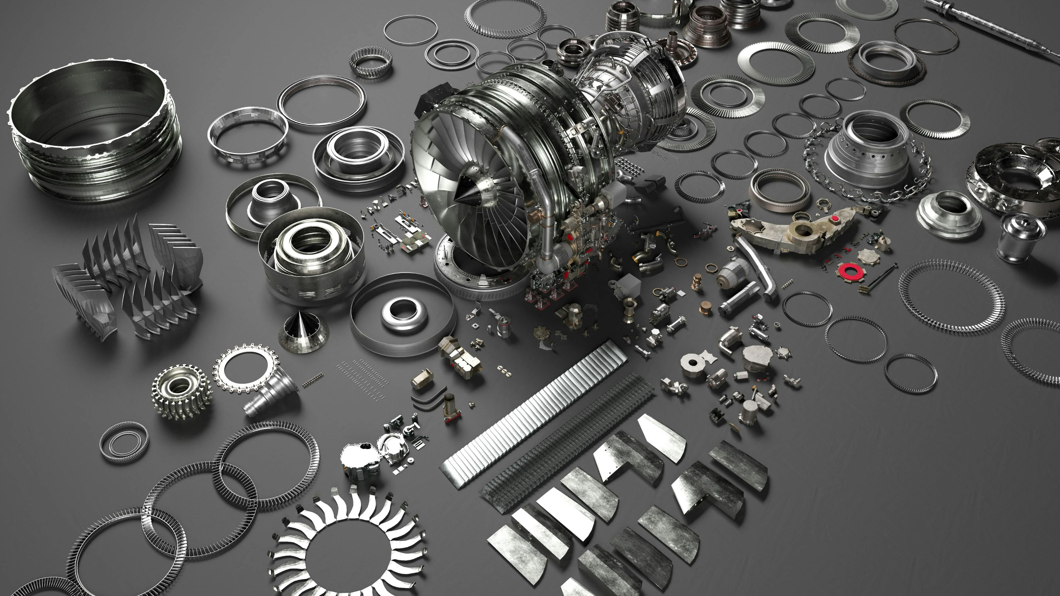 An array of metal airplane parts scattered on a dark gray surface