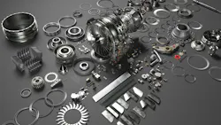 An array of metal airplane parts scattered on a dark gray surface An array of metal airplane parts scattered on a dark gray surface